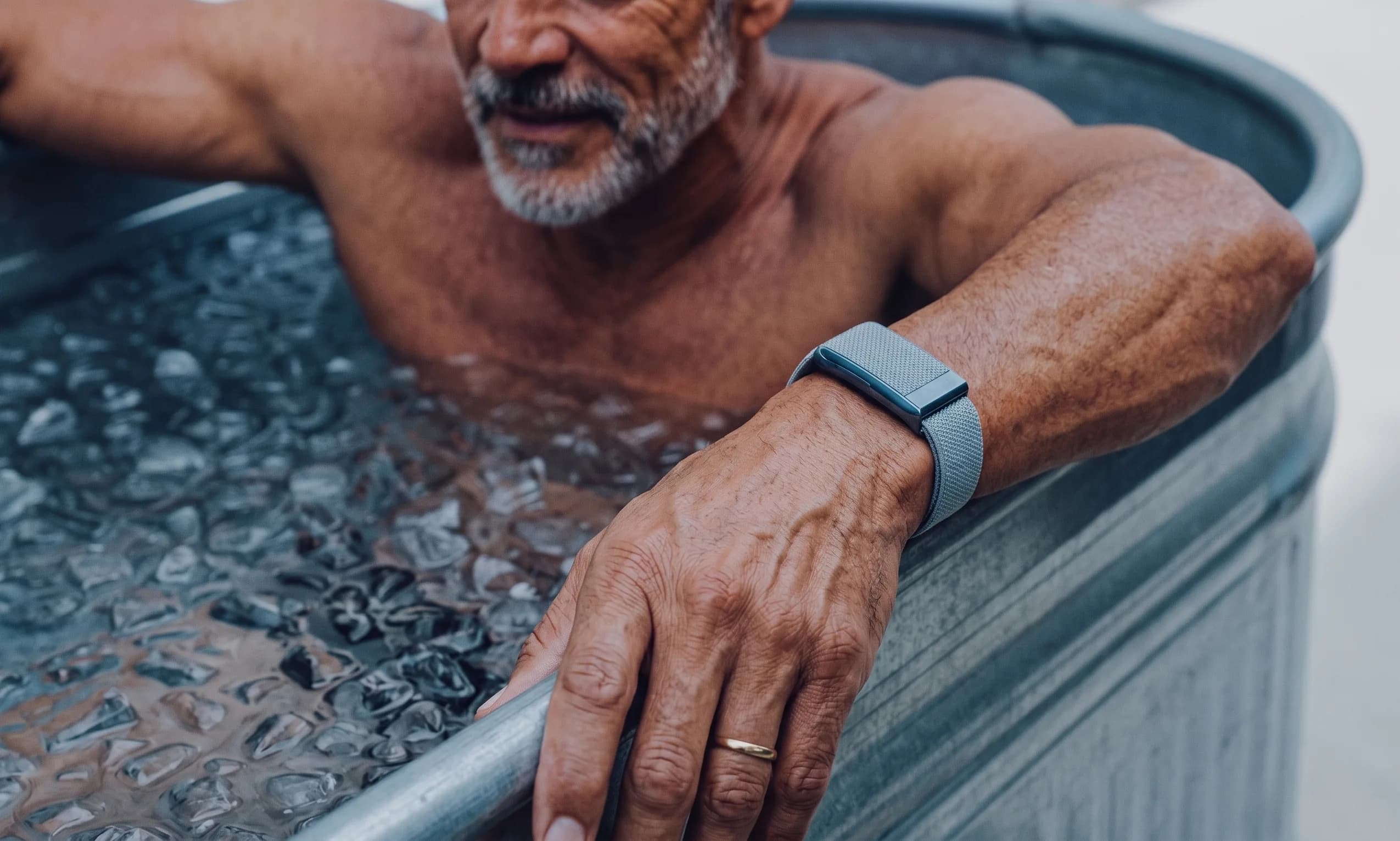 Athlete in ice bath wearing fitness tracker